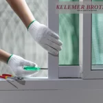 Adjusting a window frame with a screwdriver.