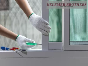 Adjusting a window frame with a screwdriver.