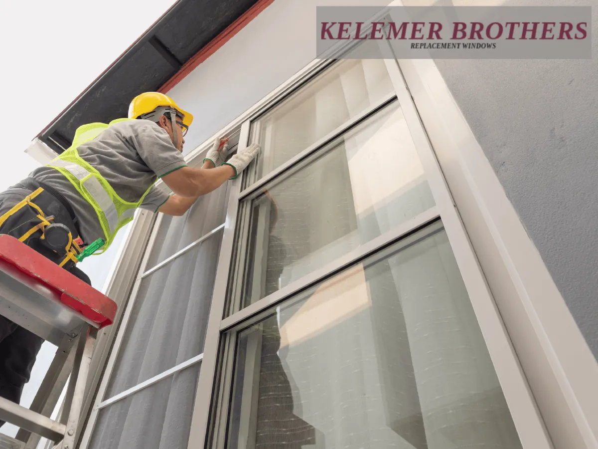 Contractor installing exterior replacement windows on a ladder