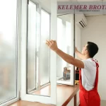 Technician installing a new residential window indoors