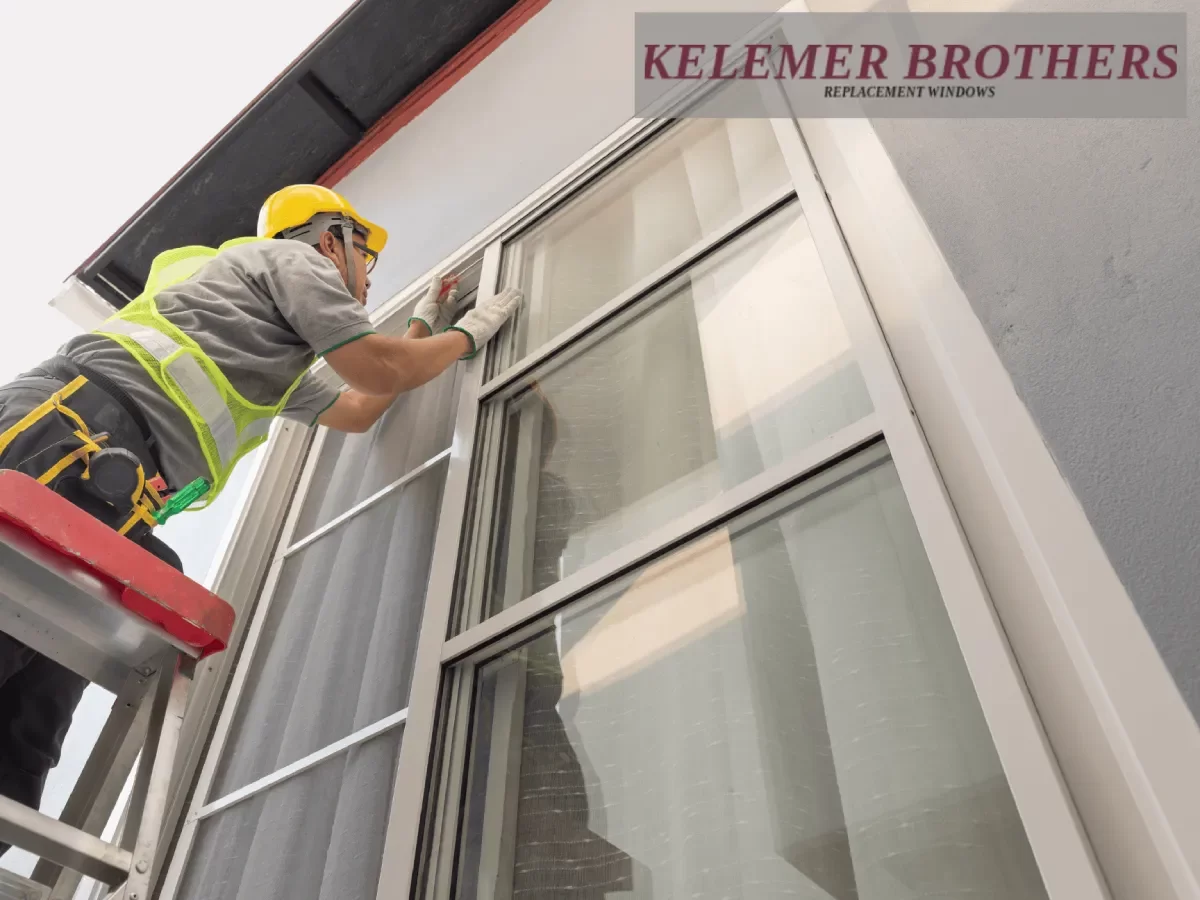 Contractor installing exterior replacement windows on a ladder